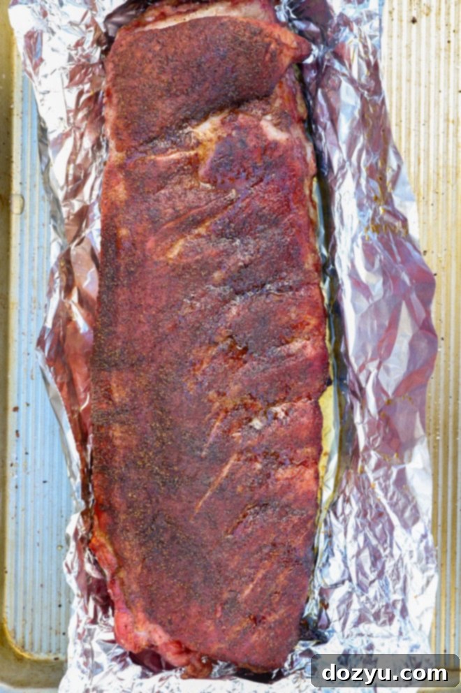 Fall-Off-The-Bone Apple Cider Traeger Ribs 6 pork rack wrapped in foil to grill