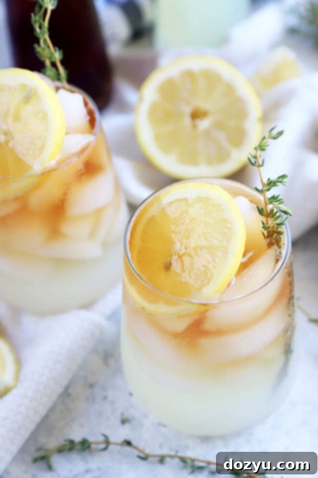 The Sparkling Arnold Palmer 9 A refreshing Arnold Palmer mocktail served in a tall glass with lemon and ice, ready to drink.