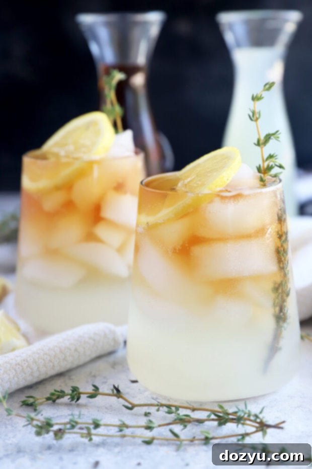 The Sparkling Arnold Palmer 10 A refreshing Arnold Palmer drink with ice and lemon slices, served in a clear glass.