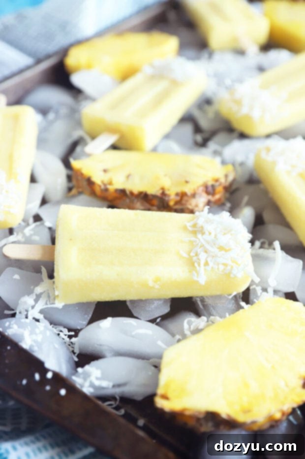 Tropical Pina Colada Popsicles 5 Pina colada popsicles on ice picture, showing their refreshing appeal as a summer dessert