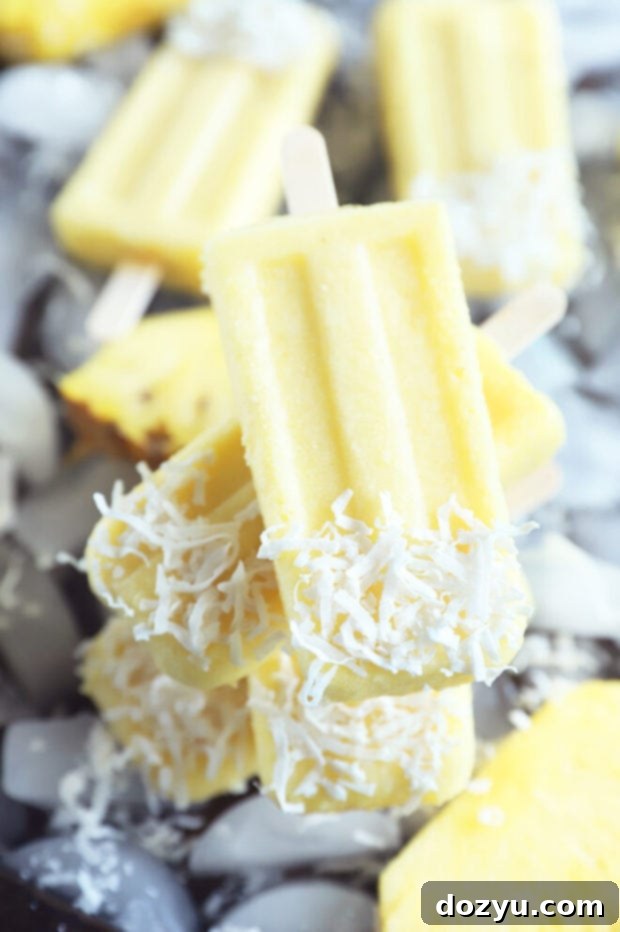 Tropical Pina Colada Popsicles 7 Stack of pina colada popsicles image, showing a close-up of the delicious frozen treats