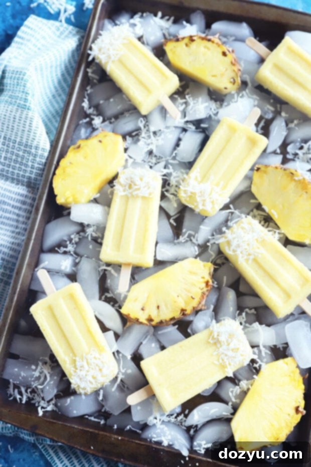 Tropical Pina Colada Popsicles 8 Overhead photo of pina colada popsicles, beautifully presented and ready to enjoy