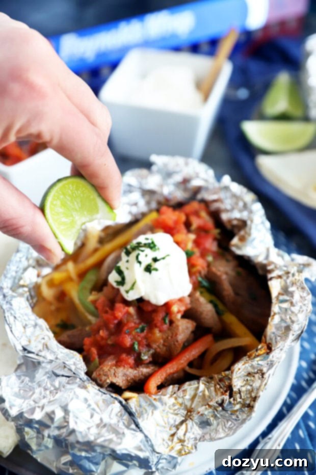 Squeezing a lime over steak fajitas image