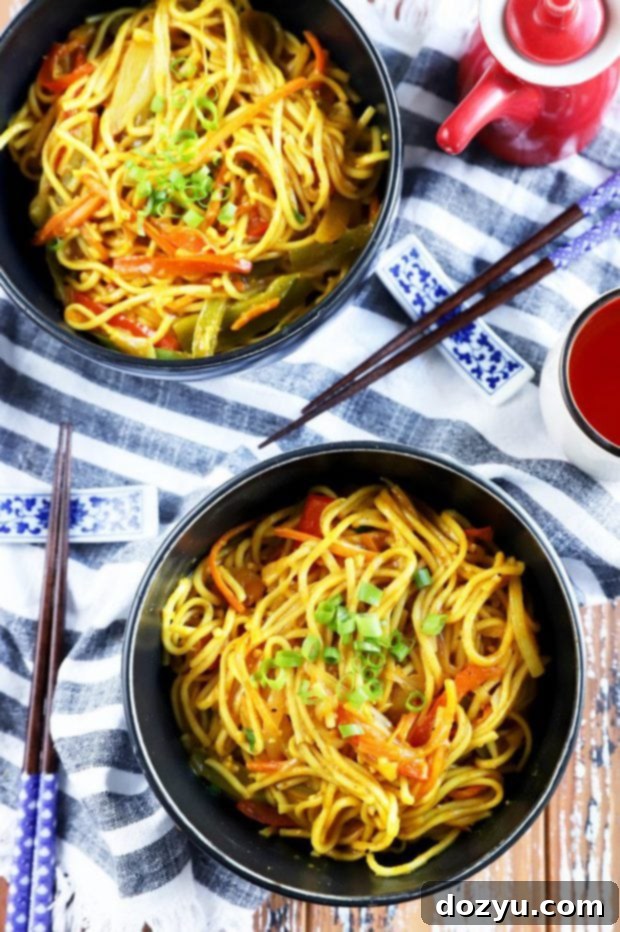 Sizzling Singapore Noodles 2 Overhead photo of Asian noodles with chopsticks