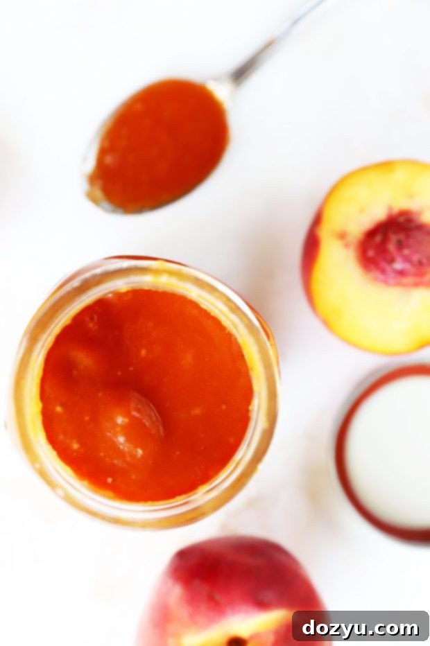 Bourbon Peach BBQ Bliss 8 Overhead shot of Bourbon Peach BBQ Sauce in a jar with peach slices