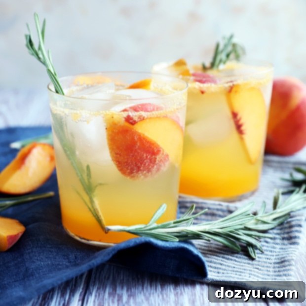 A vibrant Sparkling Rosemary Peach Mocktail, garnished with fresh rosemary and peach slices, ready to serve.