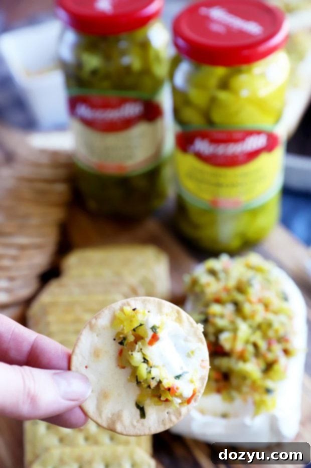 Zesty Pepperoncini Relish 10 Picture of cream cheese appetizer on cracker with relish