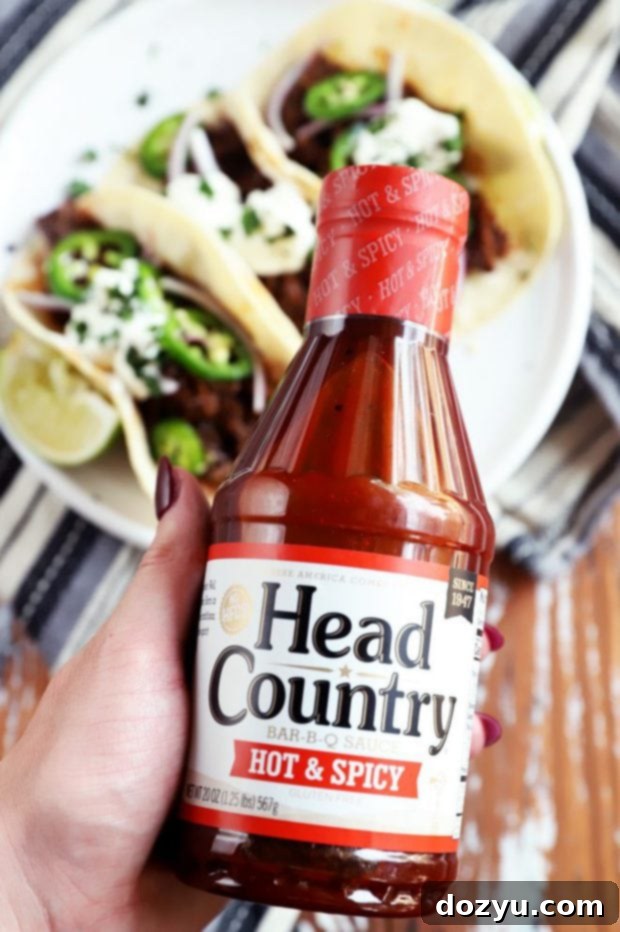 hand holding head country BBQ sauce picture