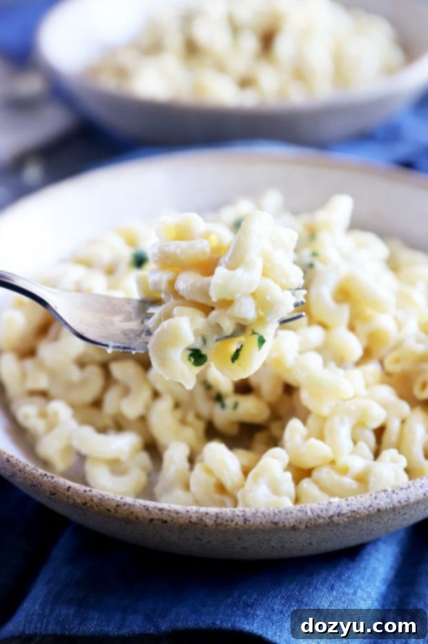 Instant Pot Creamy White Cheddar Mac and Cheese 3 Fork full of cheesy pasta image