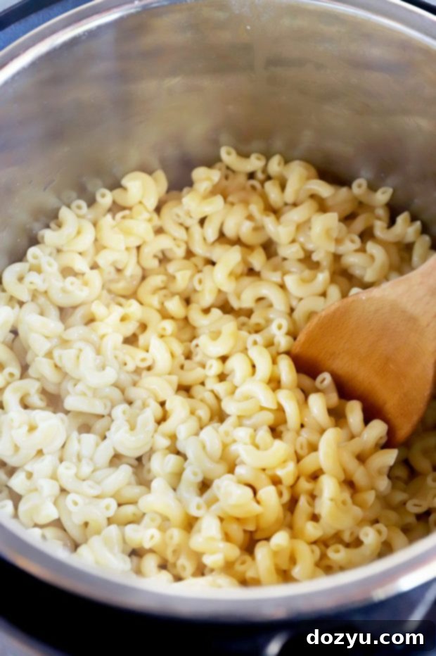 Instant Pot Creamy White Cheddar Mac and Cheese 6 Cooked macaroni in Instant Pot image