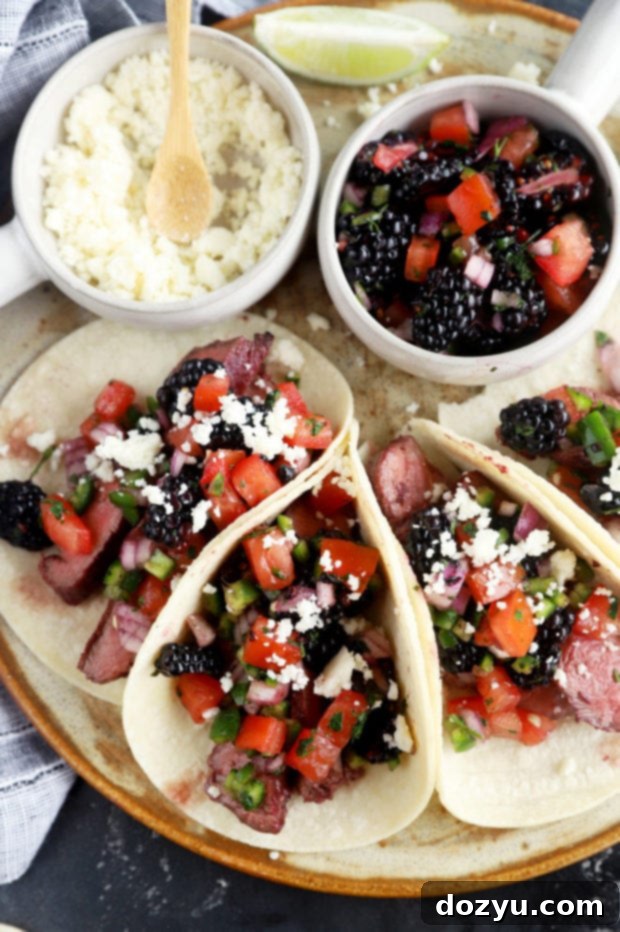 Sweet & Smoky Blackberry Steak Tacos with Zesty Salsa 2 Overhead picture of steak tacos on a platter