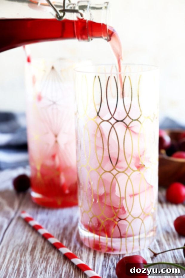 Sweet Cherry Elixir 6 Pouring cherry simple syrup into a glass image