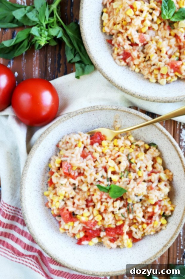 Sunkissed Corn and Tomato Risotto 2 Two bowls of creamy Summer Corn Tomato Risotto garnished with fresh basil leaves.