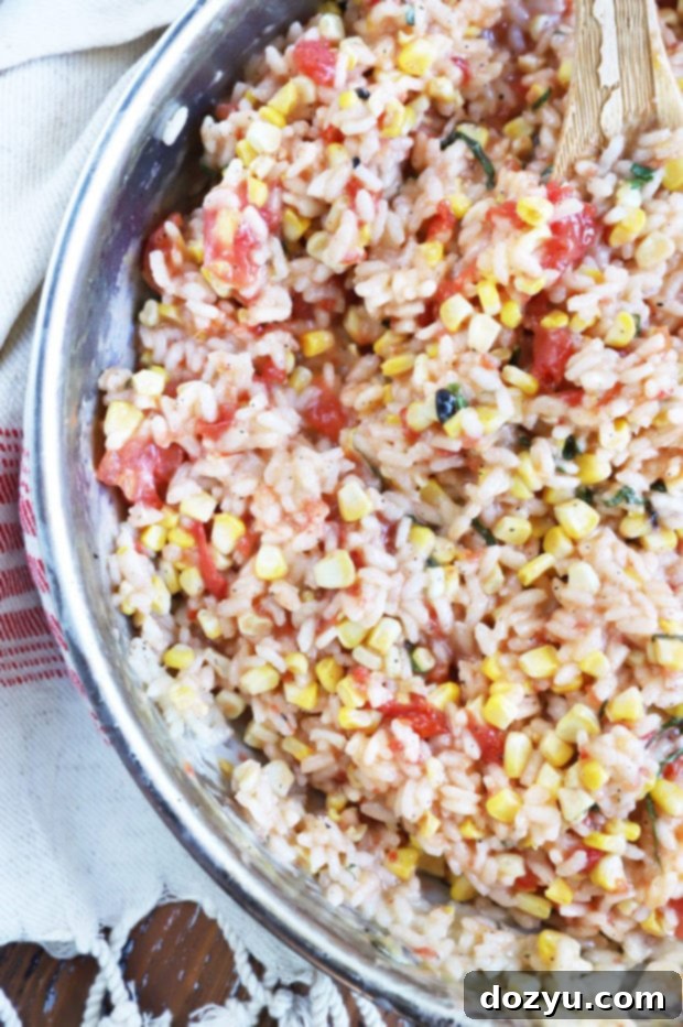 Sunkissed Corn and Tomato Risotto 6 Overhead shot of arborio rice toasting in a skillet with garlic and olive oil.