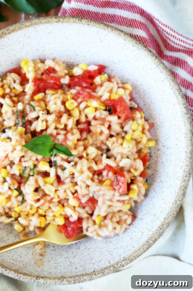 Sunkissed Corn and Tomato Risotto 7 Overhead view of a single bowl of Summer Corn Tomato Risotto, rich and creamy, with visible corn, tomatoes, and basil.
