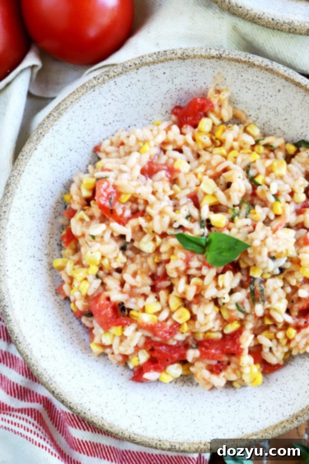 Sunkissed Corn and Tomato Risotto 8 Overhead photo of a large skillet filled with creamy Summer Tomato Corn Risotto, ready to be served.