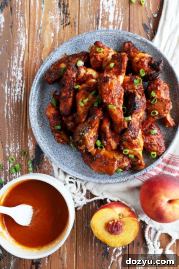 Sticky Bourbon Peach BBQ Wings 8 Overhead photo of a generous portion of grilled chicken wings on a serving dish