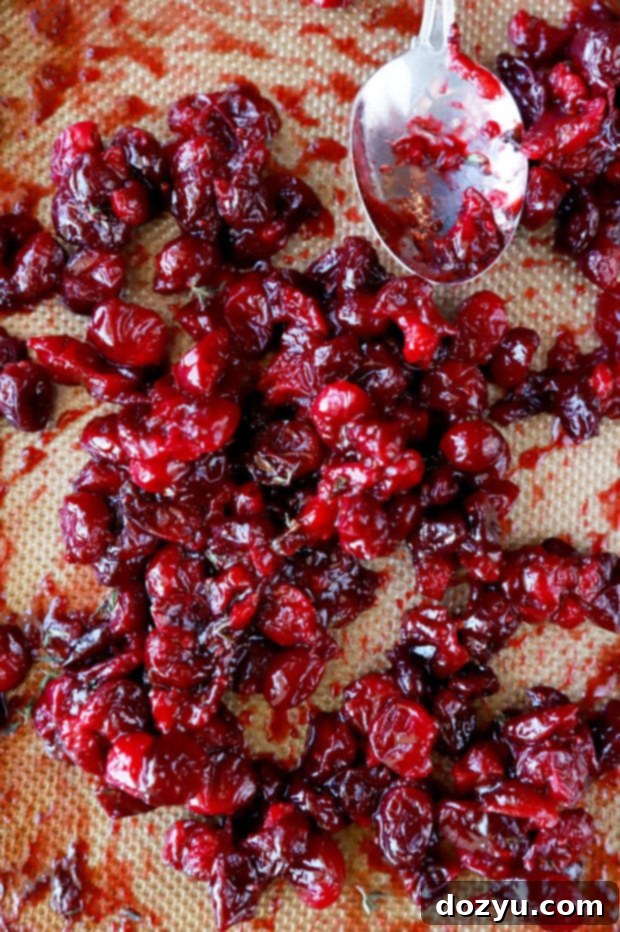 Sweet and Tangy Roasted Cranberry Goat Cheese Crostini 6 Roasted cranberries on sheet pan image