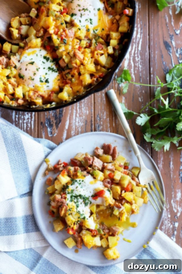 Plate of Southwestern Ham Hash, garnished with fresh cilantro and a runny egg yolk.