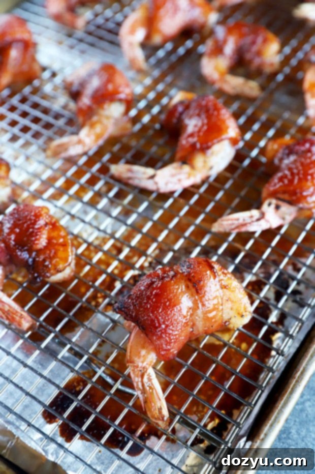 Smoky Bacon Wrapped Shrimp 7 bacon wrapped shrimp on baking sheet image