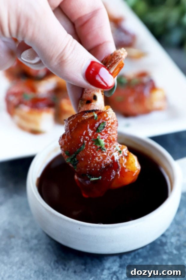 Smoky Bacon Wrapped Shrimp 9 Dipping a shrimp in BBQ sauce image