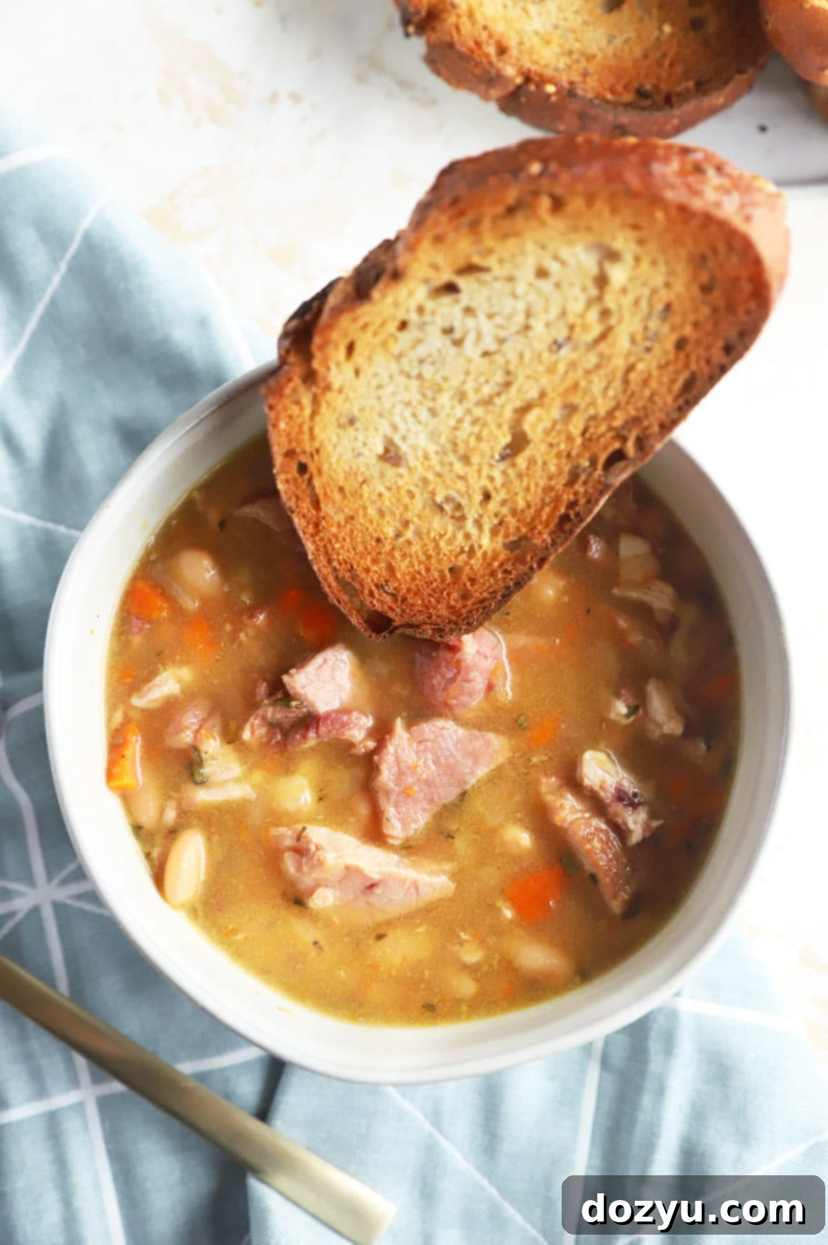 One Pot Ham and Bean Delight 3 An overhead shot of Instant Pot Ham and Bean Soup in a bowl, showcasing the rich broth, ham chunks, and beans.