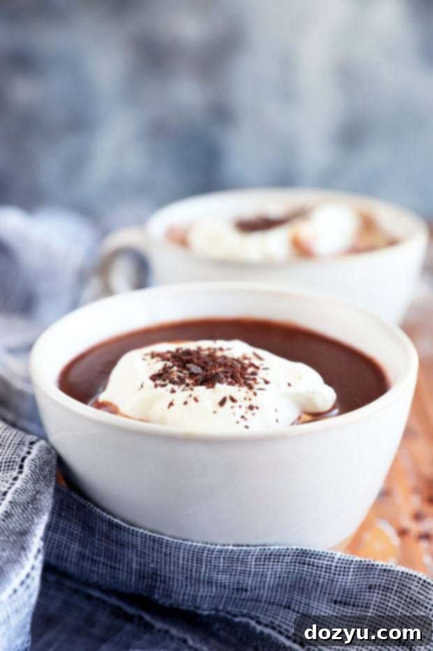 Decadent Baileys Hot Chocolate 8 Baileys Hot Chocolate garnished with whipped cream and chocolate shavings.