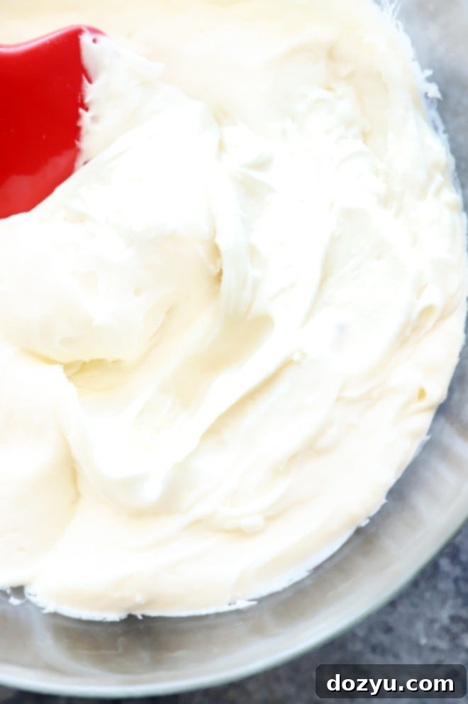 Sparkling Champagne Cream Cheese Frosting 2 Overhead image of light and creamy champagne cream cheese frosting in a white bowl