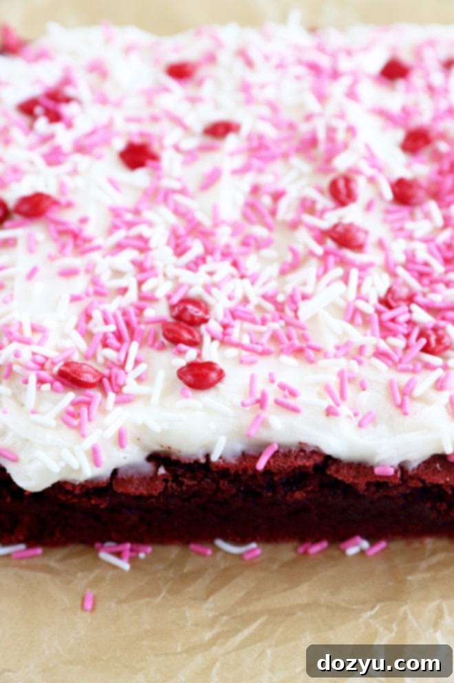 Sparkling Champagne Cream Cheese Frosting 5 Champagne frosting generously spread on a brownie square, ready to be enjoyed.