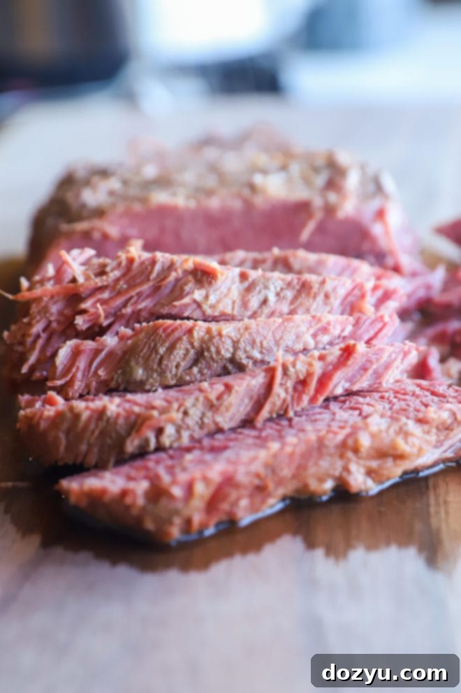 Tender Instant Pot Guinness Corned Beef 3 Image of sliced beef on cutting board
