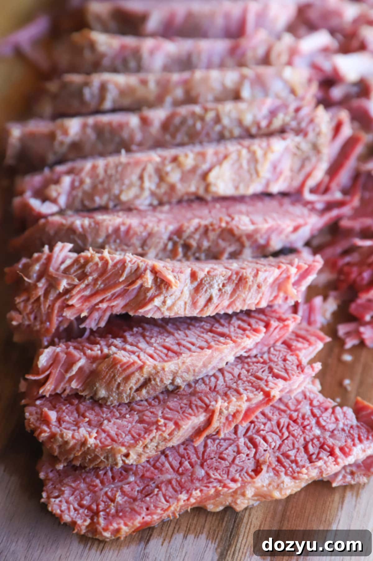 Tender Instant Pot Guinness Corned Beef 8 Sliced guinness corned beef on cutting board image