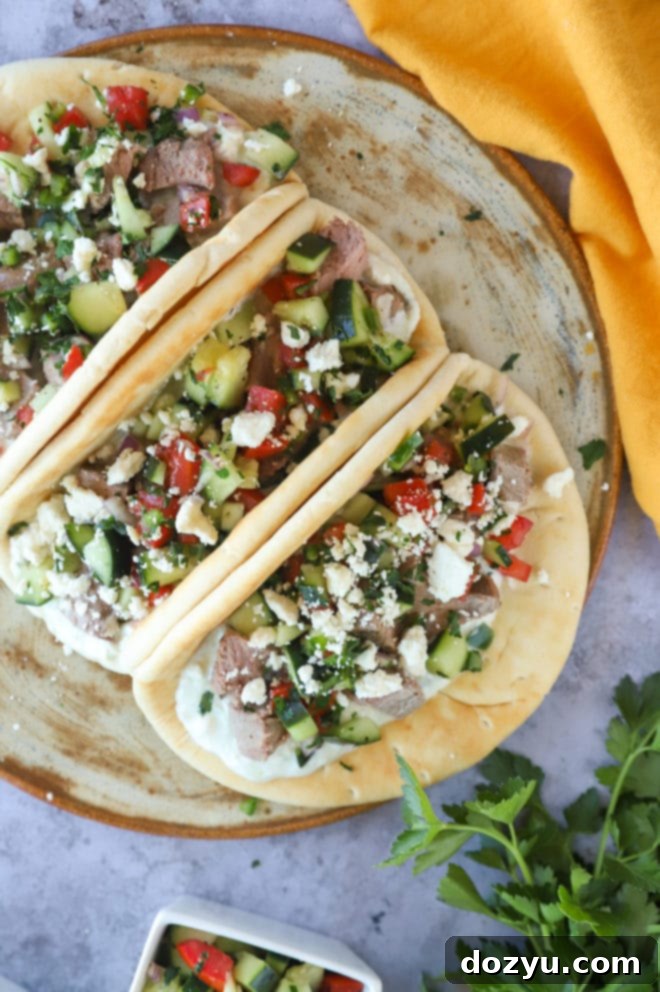 Greek Gyro Lamb Tacos 2 Overhead photo of delicious Greek lamb gyro tacos, garnished with fresh herbs and feta
