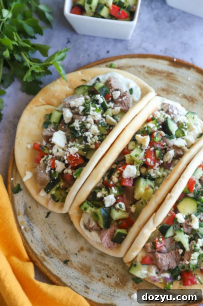 Greek Gyro Lamb Tacos 6 Lamb tacos image on platter with side of salsa and fresh garnishes