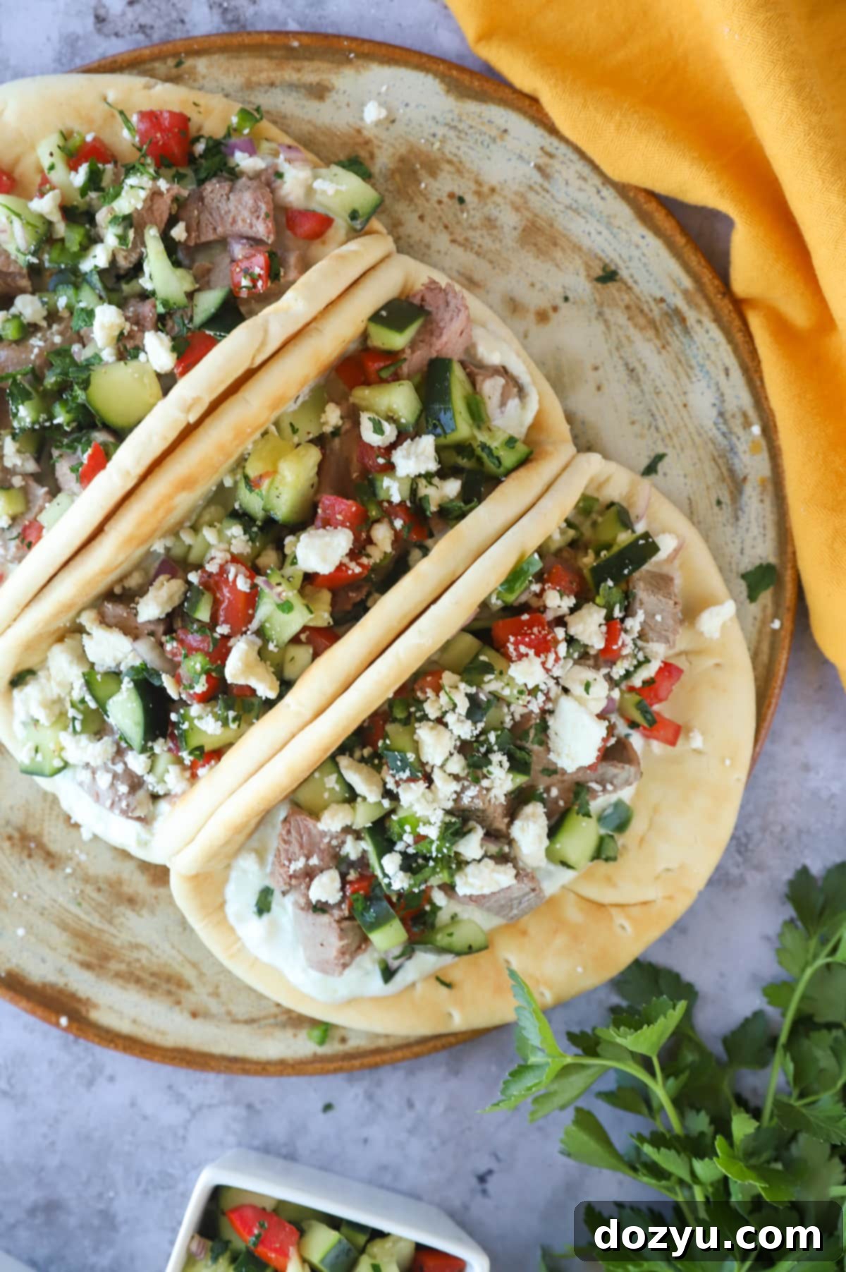 Greek Gyro Lamb Tacos 9 Overhead photo of Greek lamb gyro tacos, garnished with fresh herbs and feta