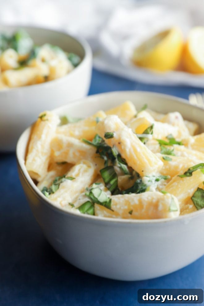 Lemony Cloud Pasta 8 Photo of rigatoni pasta in a bowl with ricotta and arugula, highlighting the texture and freshness
