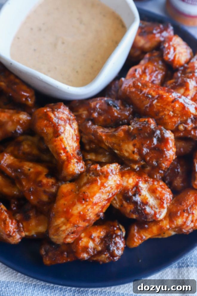Glazed Honey BBQ Chicken Wings 3 Grilled honey bbq wings artfully arranged on a platter, showcasing their glossy sauce coating and irresistible char marks