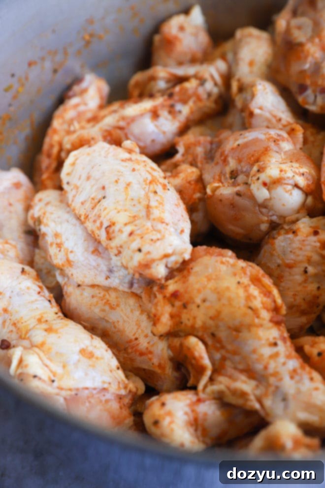 Glazed Honey BBQ Chicken Wings 5 Bowl of chicken wings coated with seasoning rub, ready for the grill, showing the meticulous preparation process