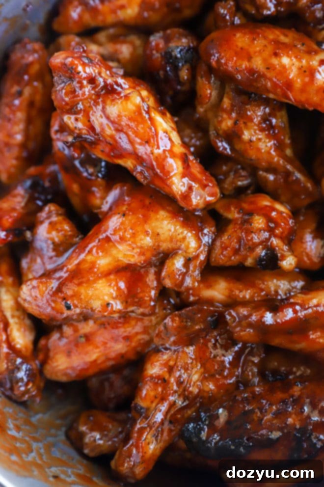 Glazed Honey BBQ Chicken Wings 6 A bowl of glossy chicken wings coated in rich BBQ sauce, highlighting the texture and readiness for serving