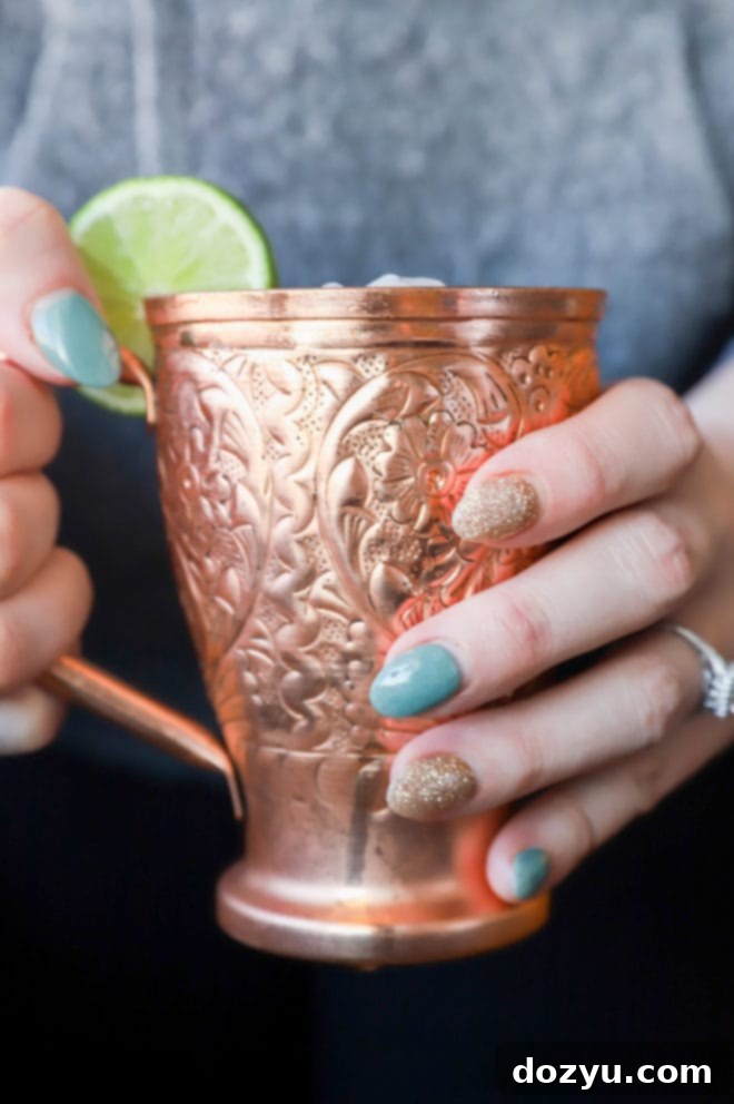 Side photo of hands holding copper mug