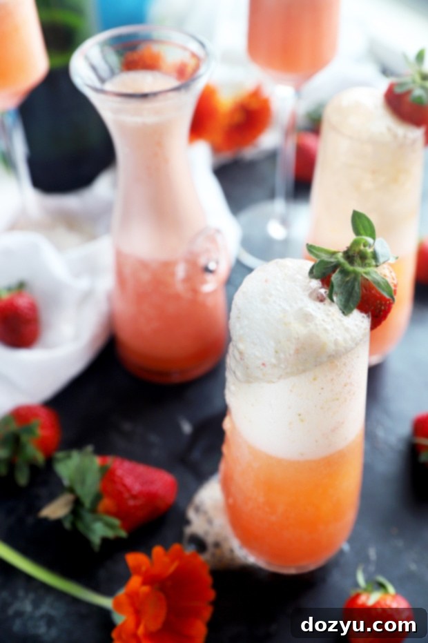 The Monthly Slice 4 Strawberry Mimosa with Fresh Strawberry Photo - A simple yet elegant strawberry mimosa, a classic brunch cocktail enhanced with fresh fruit.