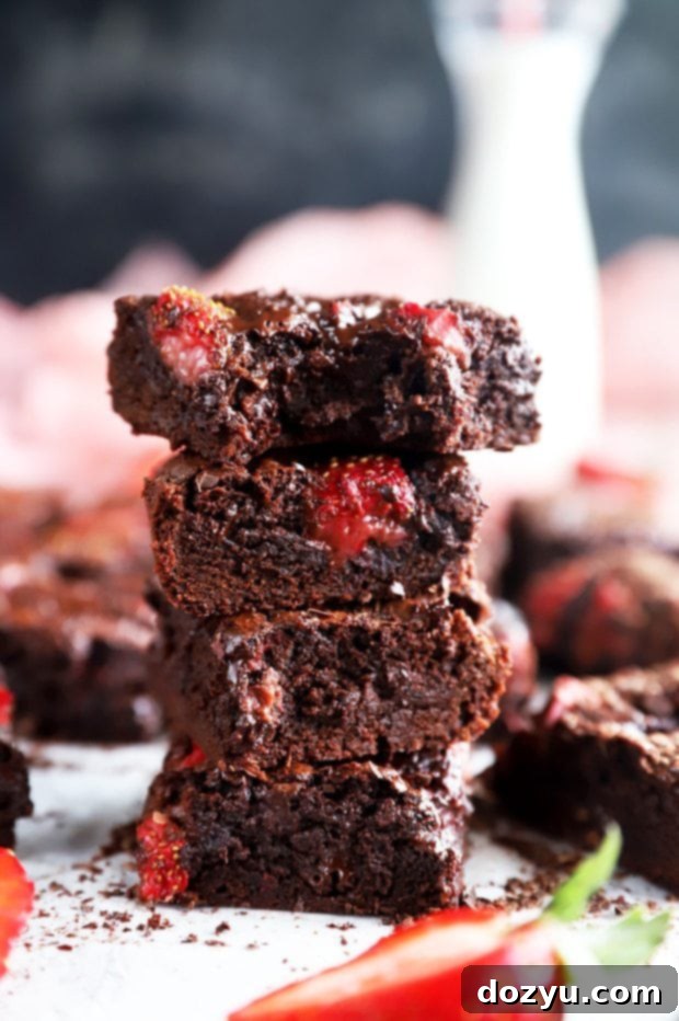 The Monthly Slice 7 Bite out of a chocolate strawberry brownie photo - Gooey, rich chocolate brownies topped with fresh strawberries, a delightful treat for any sweet celebration.