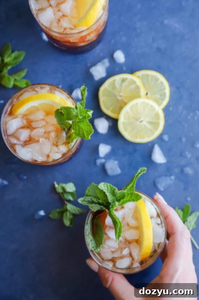 Southern Sweet Tea Mint Julep Punch 7 Hand holding a glass of mint tea cocktail