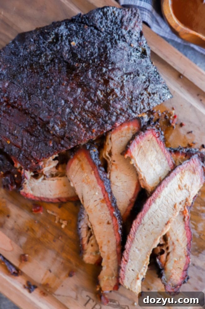 Effortless Traeger Smoked Brisket 5 sliced smoked meat on cutting board in pile