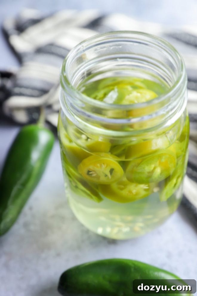 Chili-Kissed Mezcal 8 Infused mezcal with peppers in a jar image