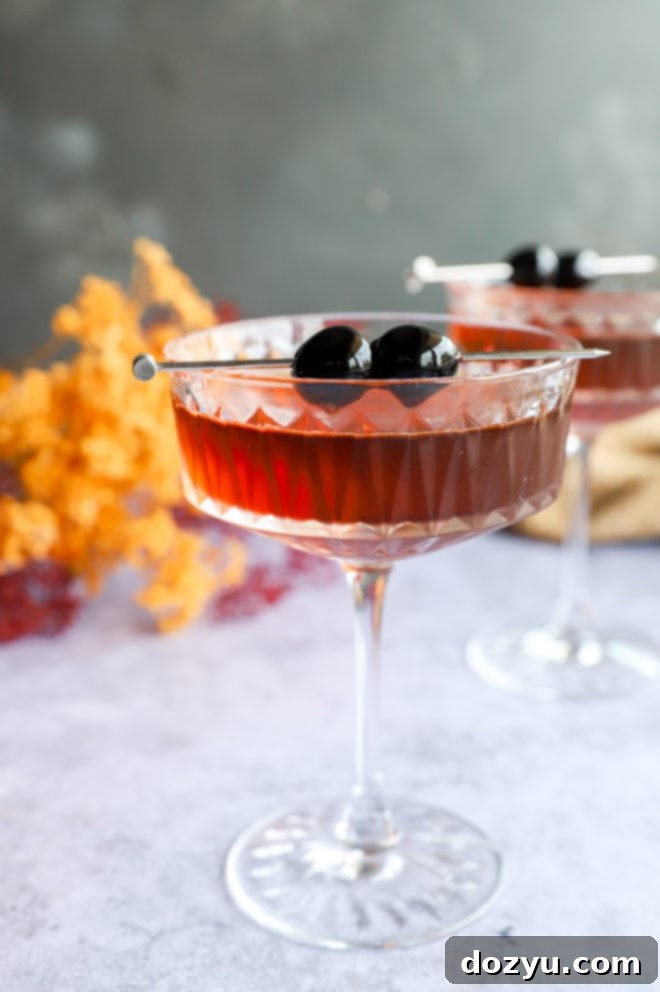 Bourbon Manhattan A Timeless Classic 5 Photo of bourbon manhattan cocktails in coupe glasses on a wooden surface