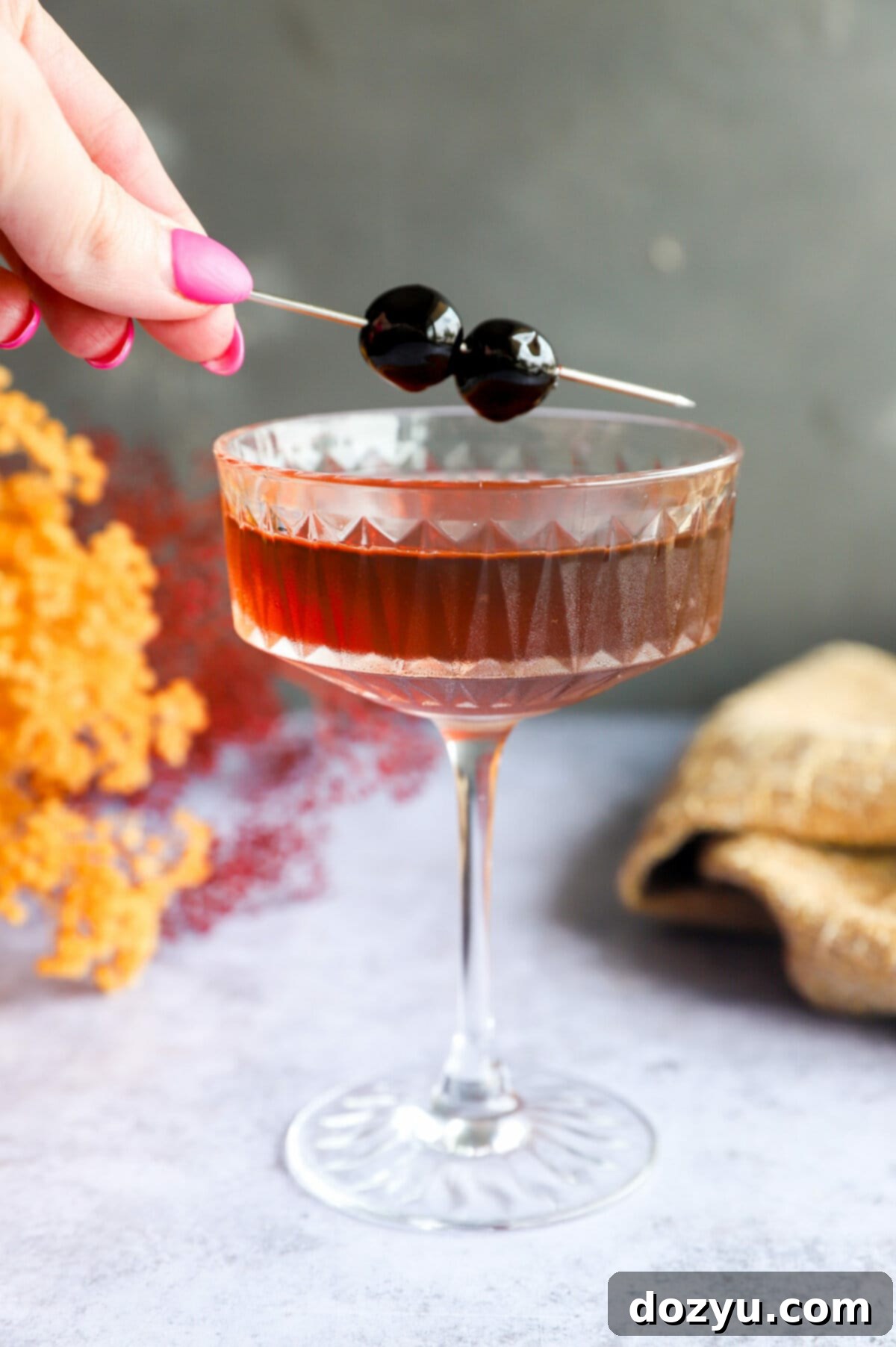 Bourbon Manhattan A Timeless Classic 8 Adding a cherry garnish to a coupe glass