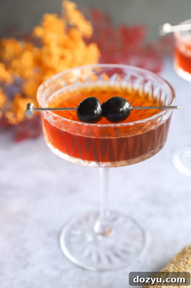 Bourbon Manhattan A Timeless Classic 4 Manhattan cocktail in a coupe glass with Luxardo cherries as garnish