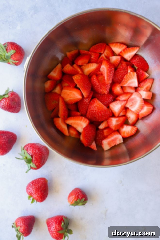 Fresh strawberries, lemon, and sugar, the ingredients for strawberry coulis