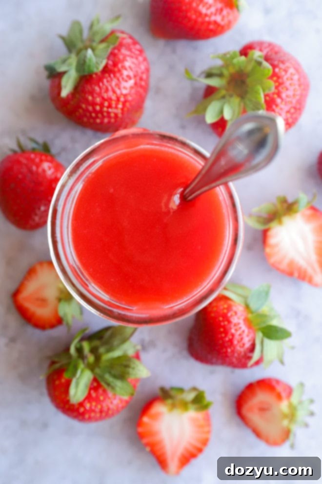 Berry sauce in mason jar with spoon
