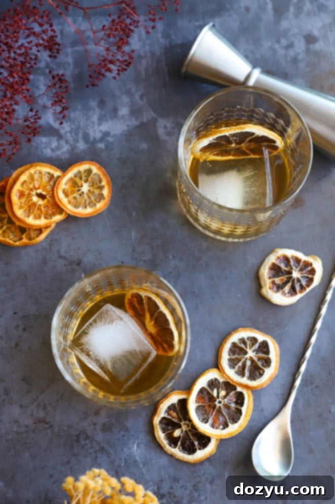 Smoldering Agave Classic 7 Image of a Spicy Mezcal Old Fashioned cocktail in a glass, with a blurred background.